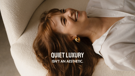 Flat lay of minimalist gold and pearl jewelry on a linen cloth, evoking a sense of calm and quiet luxury.