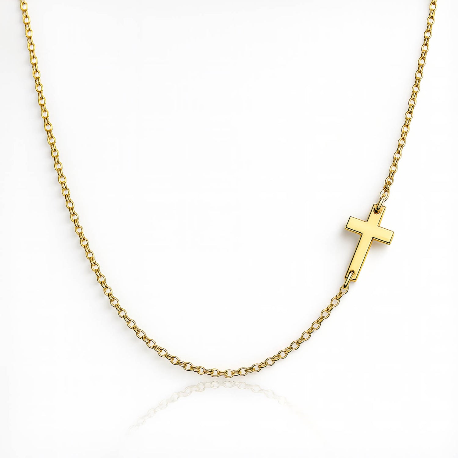Gold necklace with a small cross pendant on a white background