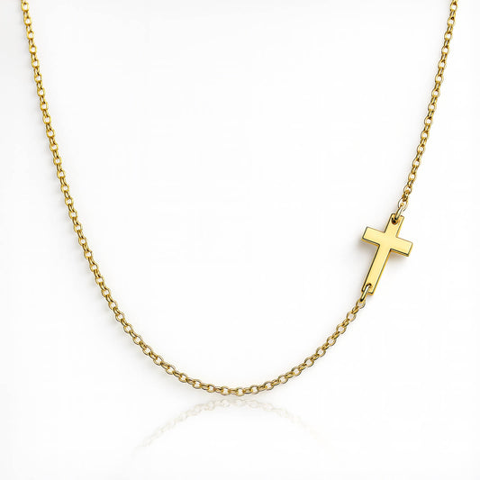Gold necklace with a small cross pendant on a white background