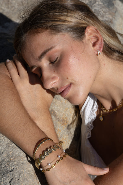 Woman with jewelry on a stone surface