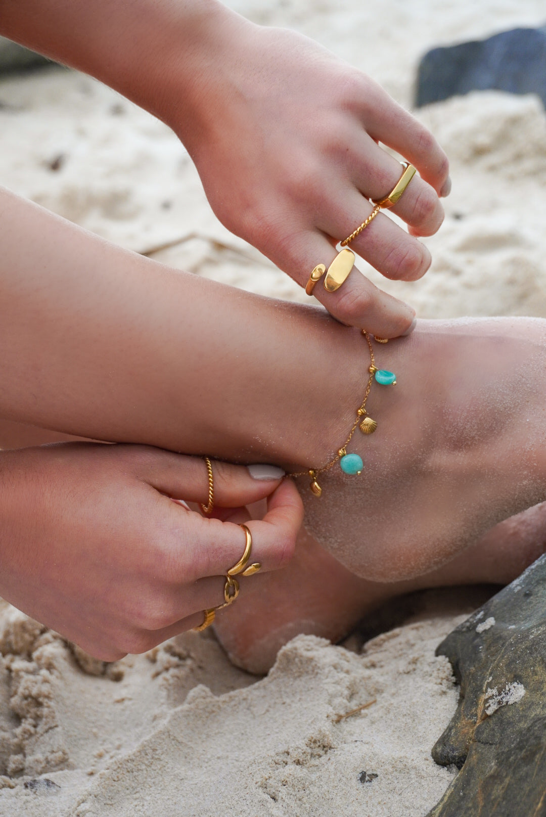 Detailed view of the gold seashell charm on the Seashell Anklet from BR Jewelry’s Verano Collection.