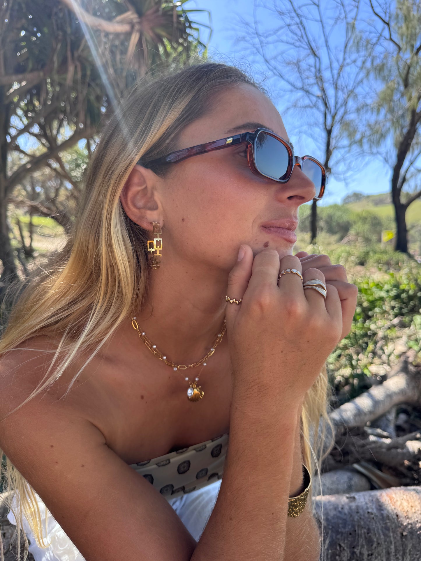 Woman wearing sunglasses with a natural outdoor background
