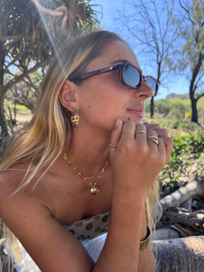 Woman wearing sunglasses with a natural outdoor background